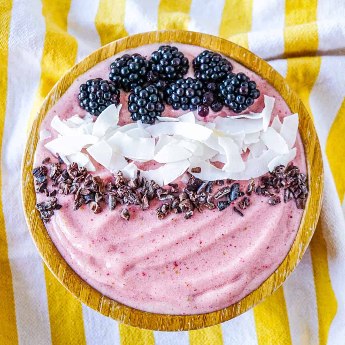 High collagen strawberry smoothie with blackberries, coconut flakes, and cacao nibs.